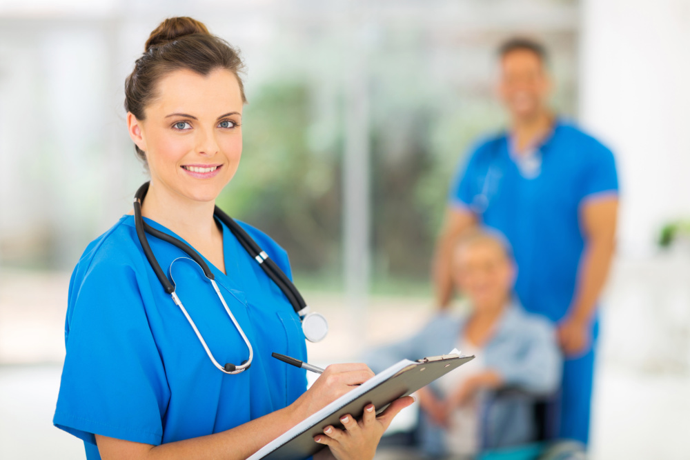 young medical doctor writing on clipboard