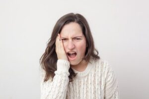 What is the 3 finger test for TMJ?