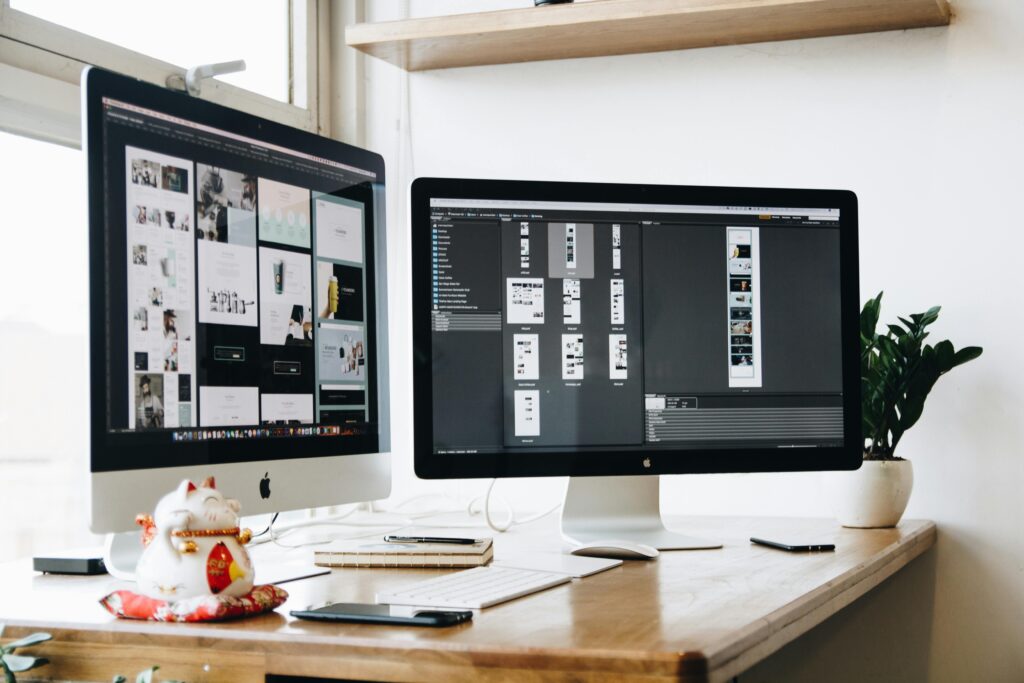 Modern UI/UX designer working on website wireframe and mobile app interface using digital tools, representing professional designing services in Dubai