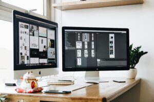 Modern UI/UX designer working on website wireframe and mobile app interface using digital tools, representing professional designing services in Dubai